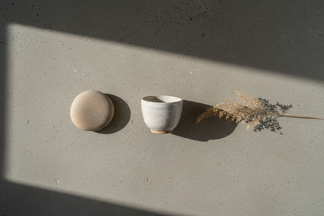 A minimal surface with a few objects and generous empty space, creating a calm and balanced visual composition.