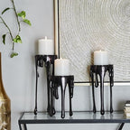 CosmoLiving by Cosmopolitan Aluminum Metal Decorative Candle Holder Pillar Candle Stand with Dripping Melting Designed Legs, Set of 3 Candlestick Holder 12", 10", 8"H, Black - color: Black